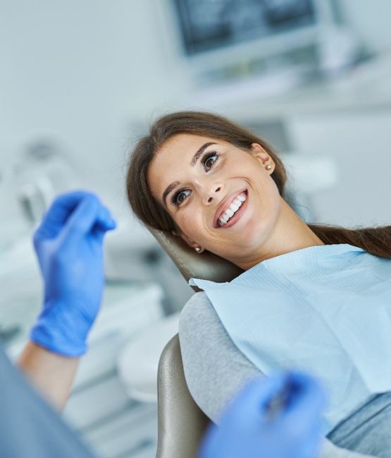 Happy, smiling male dental patient in treatment chair