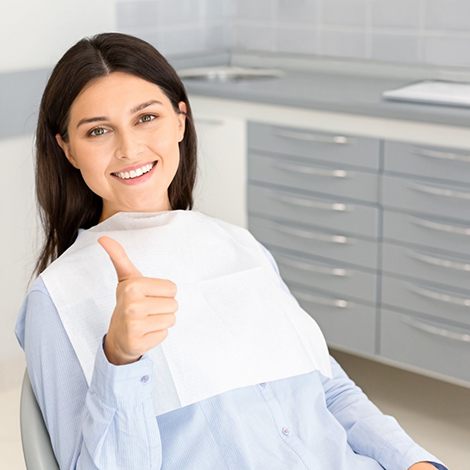 Dentist and patient engaged in friendly conversation