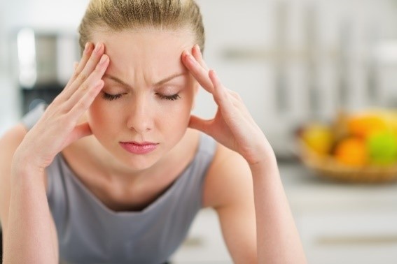 person experiencing migraine headache due to TMJ disorder